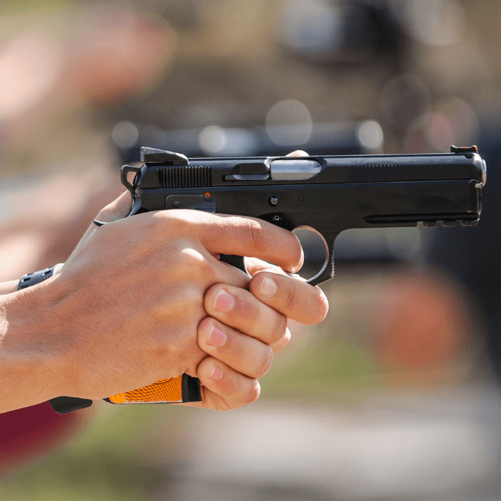 A picture of someone holding a handgun at the shooting range.